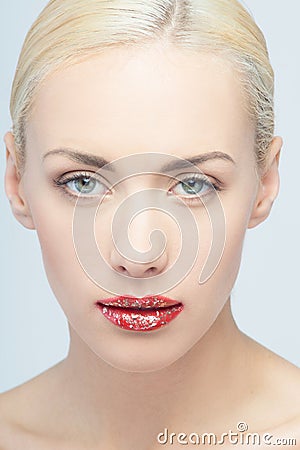 Lips of young blonde woman with vogue shining