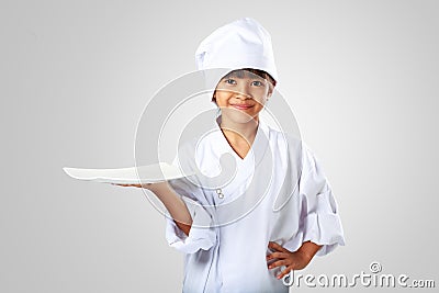 Little asian girl chef showing the empty white plate