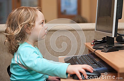 Little baby girl using a desktop computer 3