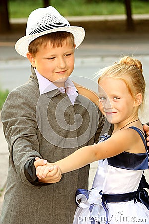 A little boy and a girl dancing a slow dance