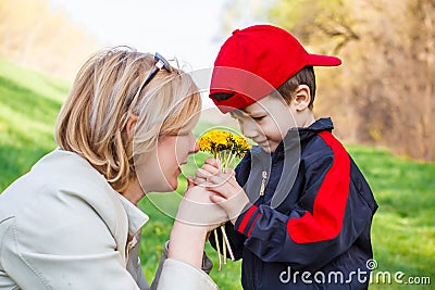 Little boy give flower to mom