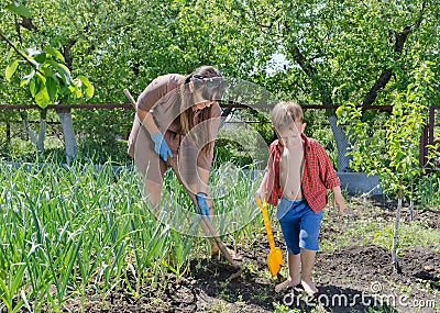 Little boy helping his mother in the garden