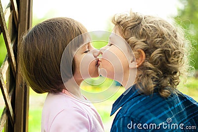 Little boy kisses girl