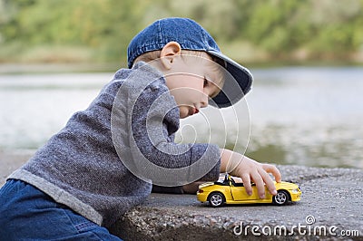 Little boy play with a car