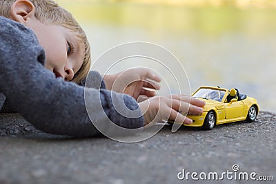 Little boy play with a car