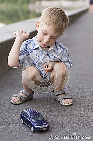 Little boy play with a car