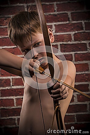 Little boy playing with bow and arrow