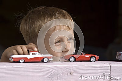 Little boy plays a toy car