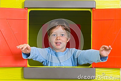 Little boy in toy house window