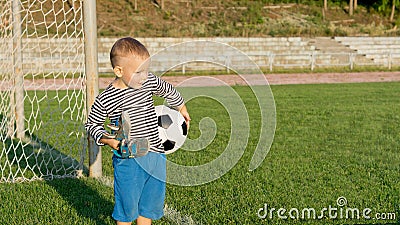 Little boy waiting to play soccer
