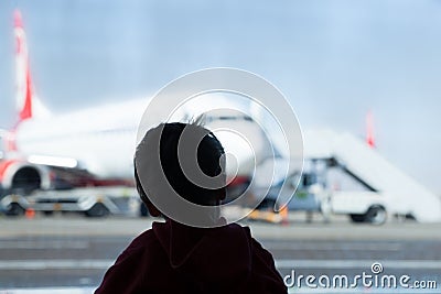 Little boy watching planes at the airport