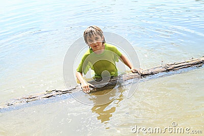 Little boy in water with trunk