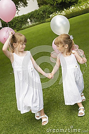 Little Bridesmaids With Balloons Walking In Garden