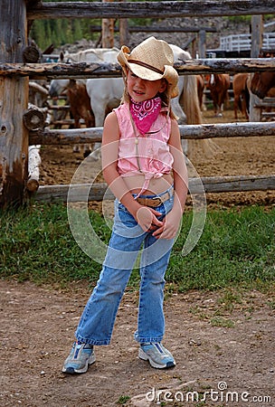 Little Cowgirl with Horse Corral Background