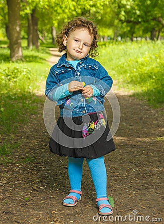 Little curly girl with soap bubbles