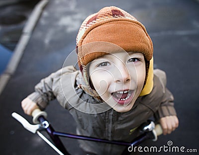 Little cute boy on bicycle smiling