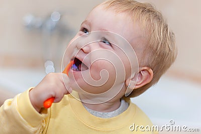 Little cute child brushing her teeth