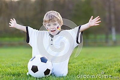 Little fan boy at public viewing of soccer or football game