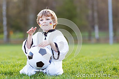 Little fan boy at public viewing of soccer or football game