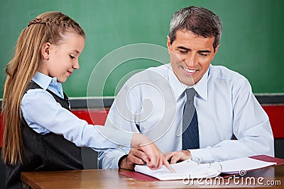 Little Girl Asking Question To Male Teacher At