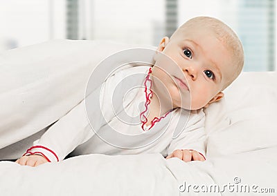 Little Girl Baby Laying Under White Blanket