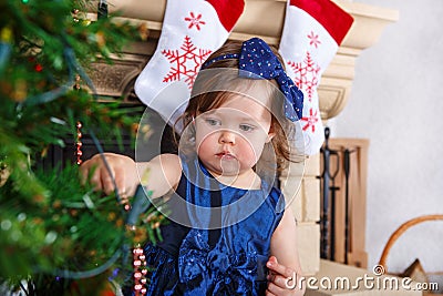 Little girl being happy about christmas tree and lights