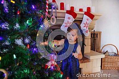 Little girl being happy about christmas tree and lights