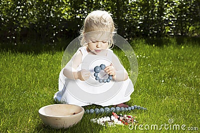 Little girl with bracelet on grass