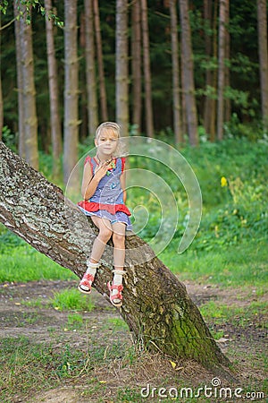 Little girl climbed on tree