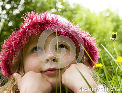 Little girl dreams in the grass