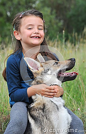 Little girl and her baby wolf dog