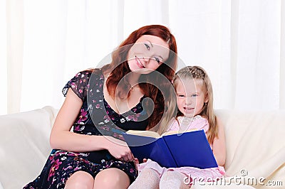 Little girl and her mother read a book