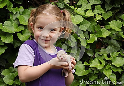 Little girl holding cat