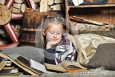 Little girl at home with a book
