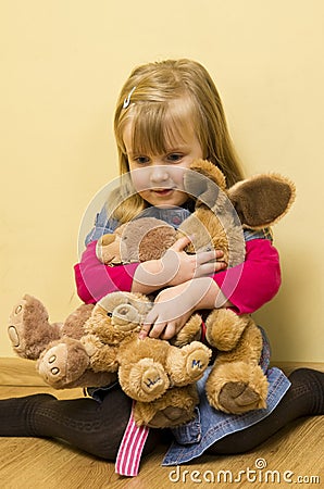 Little Girl Hugging Stuffed Animals