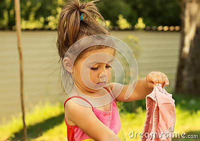 Little girl play and changes clothes