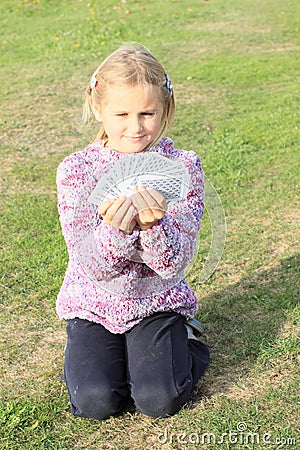 Little girl playing cards