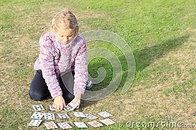 Little girl playing cards