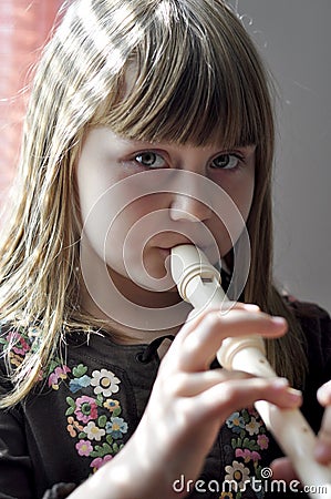 Little girl playing the flute
