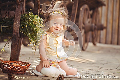 Little girl playing with rabbit in the village. Outdoor. Summer portrait.