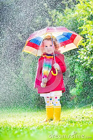 Little girl playing in the rain