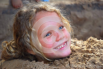 Little girl playing in sandpit