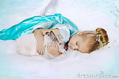 Little girl in princess dress on a background of a winter fairy