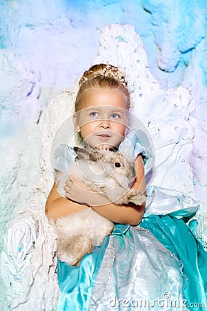 Little girl in princess dress on a background of a winter fairy