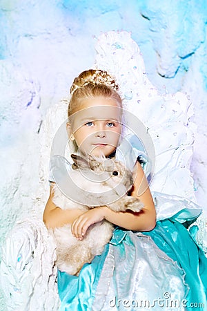 Little girl in princess dress on a background of a winter fairy
