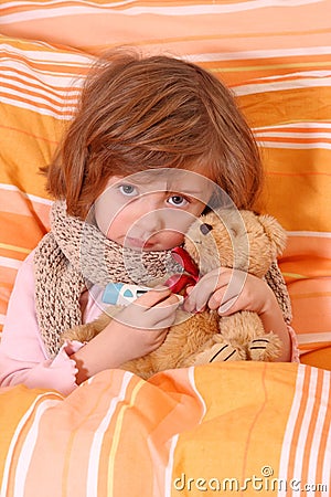 Little girl sitting sick in bed