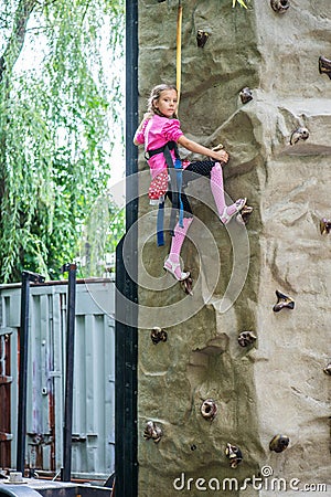 Little girl talking trains on climbing wall