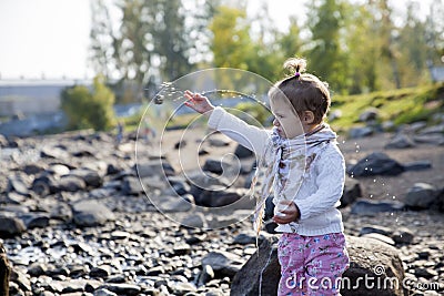 Little girl throwing the stones