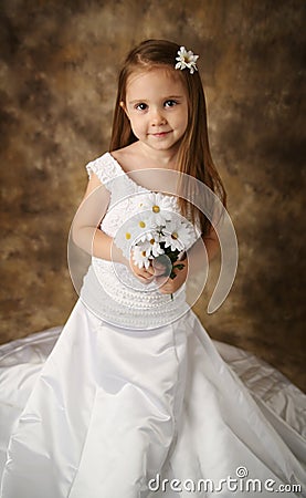 Little girl trying on mommy s wedding dress