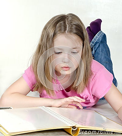 The little girl watches a photo album